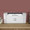 HP LaserJet M111a printer with paper output tray and printed document